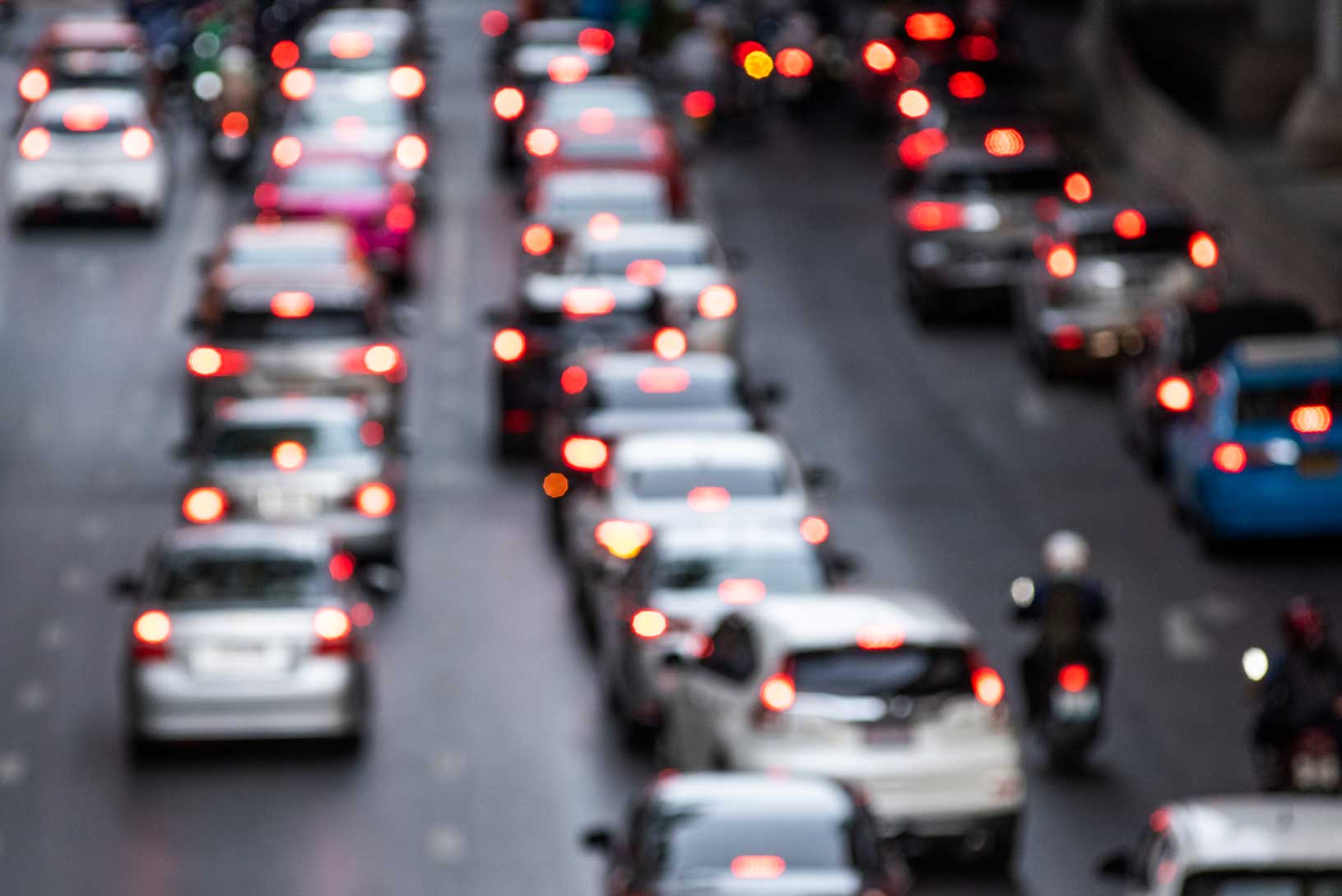 Busy rush-hour traffic on a city road at dusk